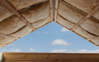 Fibreglass Insulation Installed In The Sloping Ceiling Of A New Frame House.