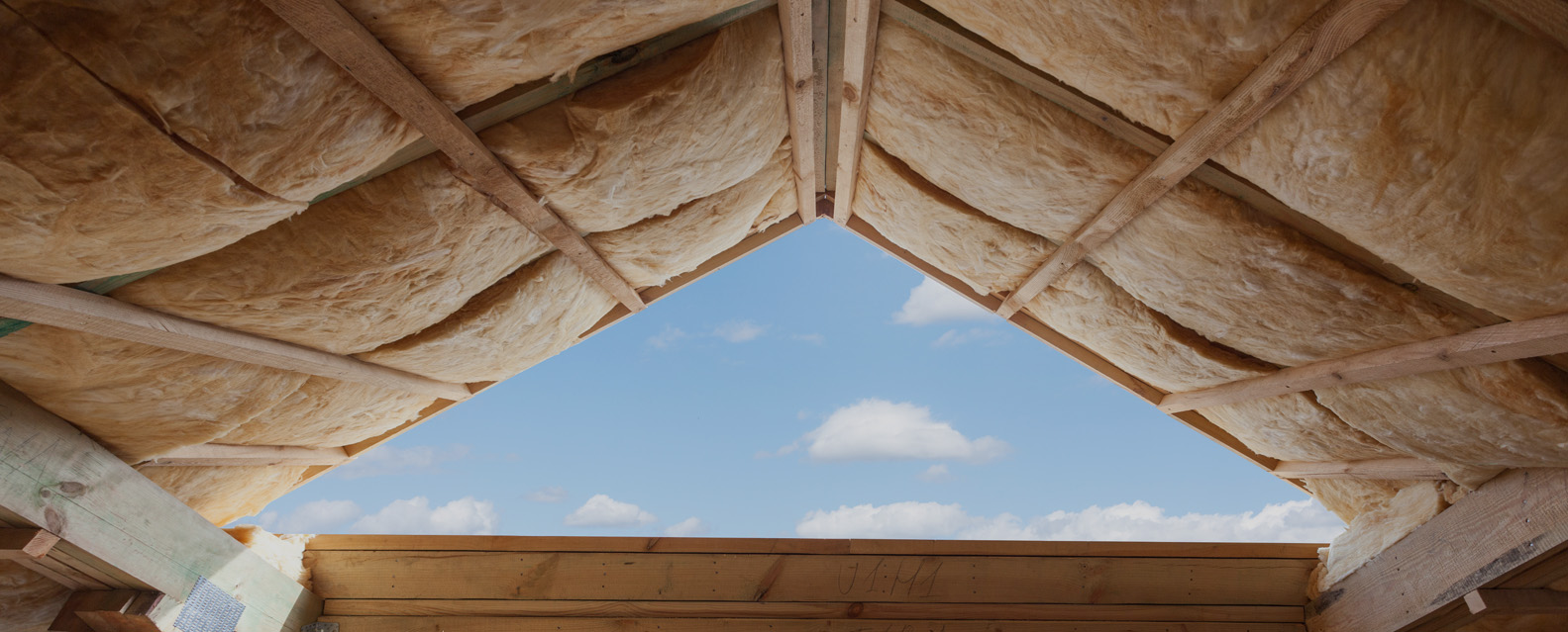 Fibreglass Insulation Installed In The Sloping Ceiling Of A New Frame House.